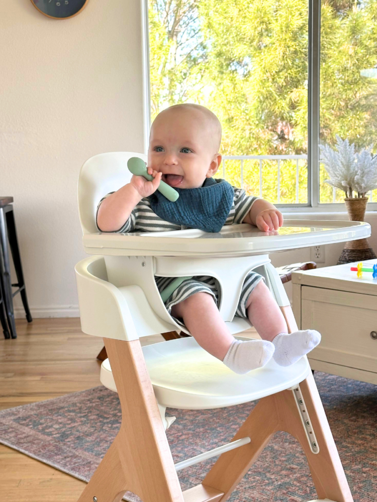 Mockingbird high chair with happy baby and Early Eaters spoon