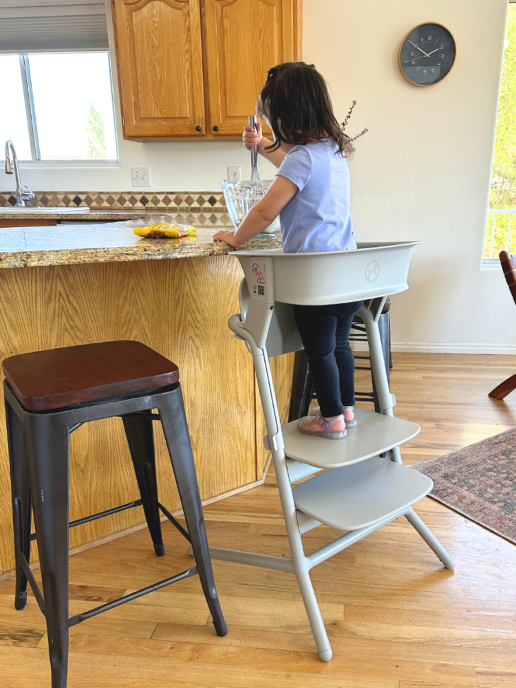 Cybex Lemo 4-in-1 chair with Learning Tower Set attached being used at the kitchen counter to help bake
