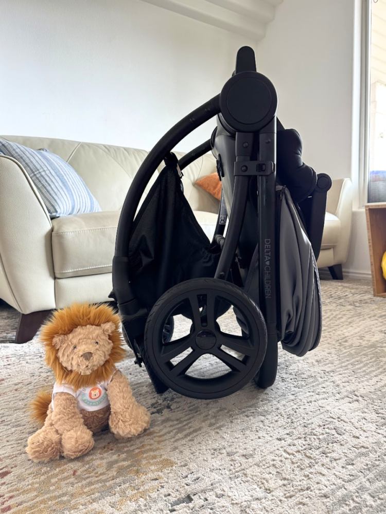 Revolve stroller folded with Baby Gear Essentials Lion
