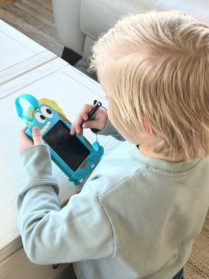 TekFun LCD writing tablet being drawn on by little boy