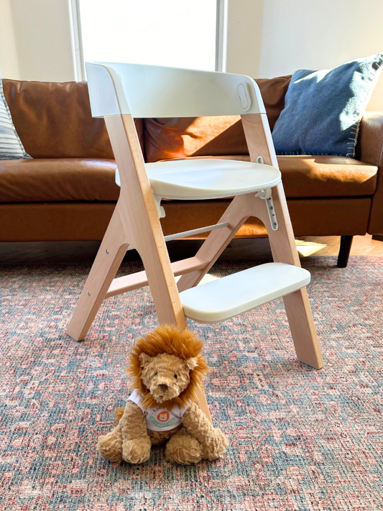 Mockingbird high chair set up as child seat with Baby Gear Essentials lion