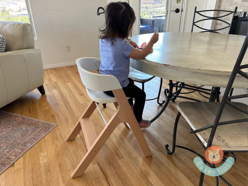 Mockingbird high chair in child seat mode at the table