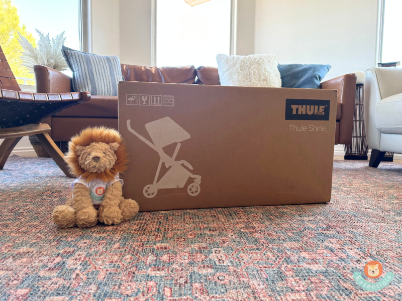 Thule Shine stroller still in the box next to the Baby Gear Essentials bear